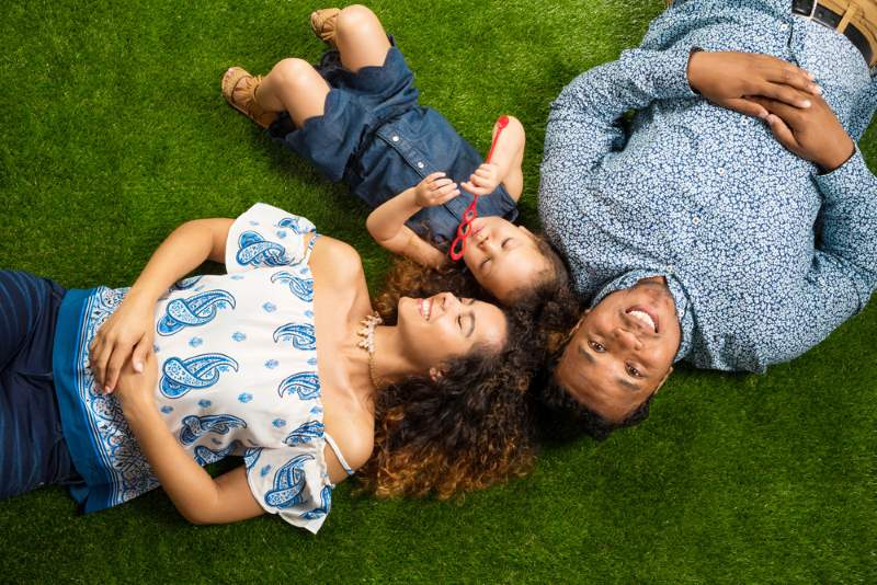 happy family lying outside together