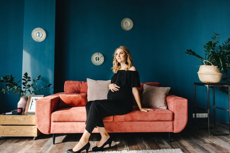 young pregnant woman sitting on a sofa